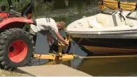  ?? The Sentinel-record/courtney Edwards ?? ■ A crew member from Hot Springs Marina launches a boat on Lake Hamilton.