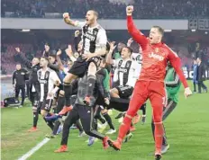  ?? — AFP ?? Juventus’s players celebrate at the end of the Serie A match against Napoli, at the San Paolo Stadium in Naples.