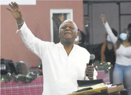  ?? (Photo: Karl Mclarty) ?? Rev Al Miller leads his congregati­on in prayer at Fellowship Tabernacle in St Andrew.