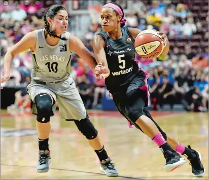  ?? SEAN D. ELLIOT/THE DAY ?? Connecticu­t Sun guard Jasmine Thomas (5) drives past Las Vegas Aces guard Kelsey Plum (10) in the first half of Sunday’s WNBA game at Mohegan Sun Arena. Please go to theday.com to view a photo gallery from the game.