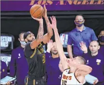  ?? Mark J. Terrill The Associated Press ?? Anthony Davis shoots over Denver ‘s Nikola Jokic for the winner and a 2-0 Los Angeles lead in the Western Conference Finals.