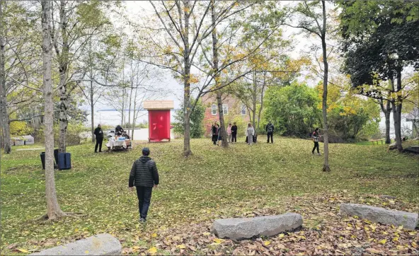  ?? KATHY JOHNSON PHOTOS ?? People arrive at The Secret Park for the unveiling and dedication of a carved panel created by renowned Mi’kmaq artist Ed Benham on Oct. 13.