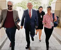  ?? Getty Images/2023 Getty Images ?? Sen. Robert Menendez, center, arrives at the U.S. Capitol ahead of a Democratic caucus meeting last week.