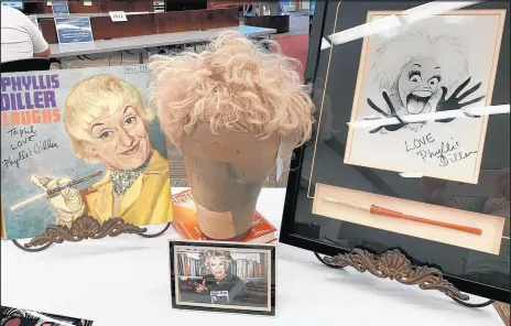  ?? PHIL POTEMPA/POST-TRIBUNE ?? One of Phyllis Diller’s original “fright” wigs and her trademark cigarette holder were among personal items that belonged to the late comedy icon displayed at a Labor Day Weekend exhibit this month in her hometown Lima, Ohio.
