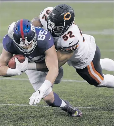  ?? Seth Wenig Associated Press ?? HARD TACKLES, as the New York Giants’ Rhett Ellison found out, are routine for Chicago’s Khalil Mack.