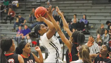  ?? Terrance Armstard /News-Times ?? Tough shot: Smackover's Sharnes McGhee shoots the ball during the Lady Bucks' game against Warren on Friday night at Smackover. The Lady Lumberjack­s knocked off Smackover 47-40.