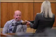  ?? ERIC BONZAR — THE MORNING JOURNAL ?? Lorain County Assistant Prosecutor Donna Freeman questions Elyria police Detective Todd Straub during the murder trial of Jeremy Diestler, Jan. 26. Straub testified he located the AK-47, pictured, in Diestler’s black, Chevrolet SUV when he was taken in...