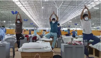  ?? — PTI ?? Patients attend the morning Yoga session organized by ITBP at Sardar Patel Covid Care Centre at Radha Soami Beas Chhatarpur in New Delhi on Friday.