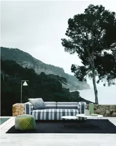  ??  ?? ABOVE: Wrapped in a new series of outdoor textiles, Antonio Citterio’s Hybrid sofa for B&B Italia brings the creature comforts of the living room to al fresco settings. The mattress-like seating features padding of different densities to cradle and support sitters. A range of striped and solid fabric options are available.