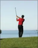  ?? GREGORY BULL — THE ASSOCIATED PRESS ?? Tiger Woods hits his second shot on the 12th hole of the South Course at Torrey Pines Golf Course during the final round of the Farmers Insurance Open Sunday in San Diego.