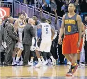  ?? JOHN RAOUX/ASSOCIATED PRESS ?? Magic players and coaches celebrate after Nik Vucevic’s game-winning shot beat Jeff Teague (0) and the Hawks.