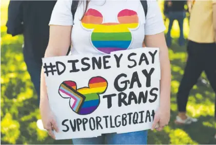  ?? AP PHOTO/JAE C. HONG ?? Disney employee Tiffany Cooper holds a sign to protest the company’s stance on LGBTQ issues in Glendale, Calif., in March.