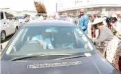  ?? ?? First Lady Dr Auxillia Mnangagwa talks to motorists about the importance of not throwing litter through car windows during a clean-up campaign in Harare’s Central Business District yesterday