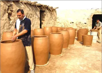  ??  ?? Kawwaz’s own family drew their name from the jug, or “kawz” in Arabic, which they have produced for more than 200 years from clay found at a lake by Najaf.