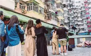  ?? AFP PIC ?? People lining up to take a photo at a popular Instagram spot in Hong Kong recently.