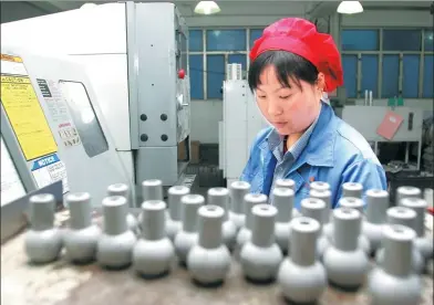  ?? PROVIDED TO CHINA DAILY ?? A worker checks quality of alloy products at Dongguan Eontec Co Ltd in Guangdong province.