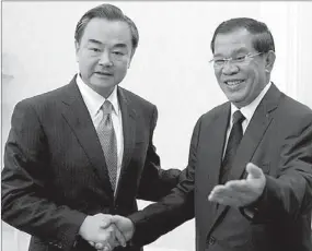  ?? TANG CHHIN SOTHY / AGENCE FRANCE-PRESSE ?? Chinese Foreign Minister Wang Yi (left) meets Cambodian Prime Minister Hun Sen at the Peace Palace in Phnom Penh on Wednesday. Wang Yi arrived in Cambodia on Tuesday for an official visit.