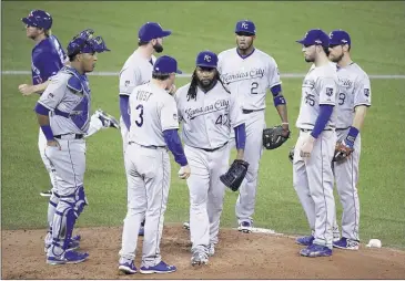  ?? DARREN CALABRESE/THE CANADIAN PRESS VIA AP ?? Royals starter Johnny Cueto (center) walks off the mound after handing the ball to manager Ned Yost during the third inning in Game 3 of the American League Championsh­ip Series against the Blue Jays on Monday night in Toronto.