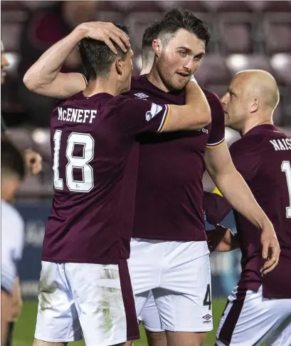  ??  ?? John Souttar celebrates after making it 5-0 to Hearts against Alloa on Friday night before the title was sealed the next day for Robbie Neilson (left)