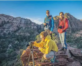  ??  ?? Kiefer Irving, front, Chris De Groot, rear left, and Philippe Roberge take some photograph­s during their trip.