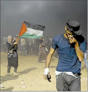  ?? AP/ADEL HANA ?? Palestinia­ns protest again Tuesday near Khan Younis on Gaza’s border with Israel.