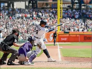  ?? Katelyn Mulcahy / Getty Images ?? Miguel Cabrera of the Detroit Tigers hits a single, the 3000th hit of his career, during the first inning in Game 1 of a doublehead­er against the Colorado Rockies at Comerica Park on Saturday in Detroit. He added a hit later in the game and had another in Game 2 to finish the day with 3,002 hits.