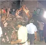  ??  ?? Rescuers search wreckage of four-storey building in Indore for survivors after incident on Saturday night