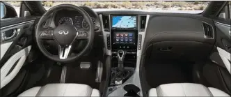  ??  ?? The dash layout is functional, although unspectacu­lar. It avoids the current trend of making the entire gauge area into one big touch-screen. The shiny trim on the center console will not be to everyone’s liking.