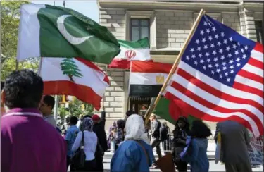  ?? CRAIG RUTTLE — THE ASSOCIATED PRESS FILE ?? In this Sunday, Sept. 25 2016, photo, marchers carry the national flags of Pakistan, top left, Lebanon, bottom left, Iran, top center, Egypt, bottom center and the American flag, right, during the Muslim Day Parade on Madison Avenue in New York. U.S....