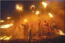  ?? ?? Villagers hold torches during a torch light festival outside a shrine at village Aishmuqam in Anantnag district, about 70 km south of Srinagar, the summer capital of Indian-controlled Kashmir, April 22. (Xinhua)