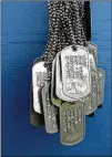  ??  ?? At the exhibit’s entrance, a wall holds military chains identifyin­g the 896 South Carolinian­s who died in Vietnam.