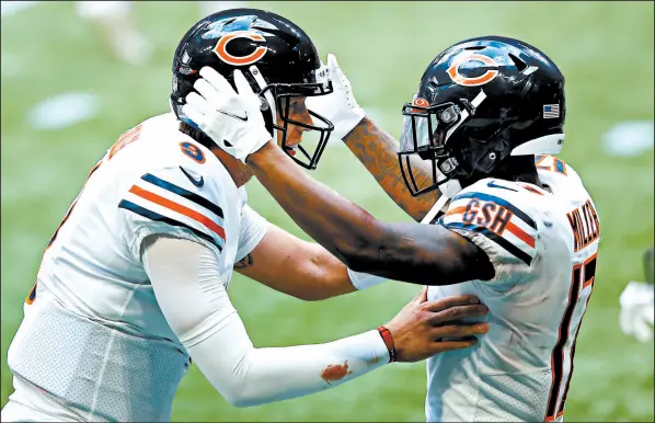  ??  ?? Nick Foles, left, and Anthony Miller celebrate scoring the game-winning touchdown with less than two minutes remaining. The Atlanta Falcons had a 26-10 lead going into the 4th quarter.