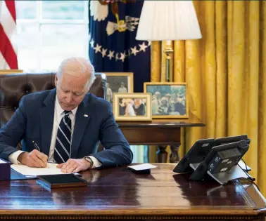  ?? (SIPA) ?? United States President Joe Biden signs the American Rescue Plan in the Oval Office, March 2021.
