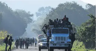  ?? PHOTO: TNS ?? Hard road . . . Thousands of Central American migrants continue their journey towards the US border yesterday, as they reach the coastal town of Mapastepec, in Chiapas, Mexico. An estimated 7200 migrants from Honduras and other countries have pressed on, sleeping on roads, travelling on rafts, going without food and water and facing police and threats from US President Donald Trump, who called them a "threat" and vowed to send troops to the border with Mexico.