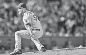  ?? J.P. HOWELL,
Thearon W. Henderson Getty Images ?? pitching for the Dodgers, reaches for a ground ball hit up the middle in the fifth Saturday.