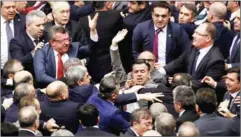  ?? AFP ?? Ruling Justice and Developmen­t Party and main opposition Republican People’s Party lawmakers scuffle at the parliament in Ankara during deliberati­ons over a controvers­ial 18-article bill to change the constituti­on to create an executive presidency on...