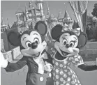  ?? DISNEYLAND ?? Mickey and Minnie Mouse will have to keep their distance from guests once Disneyland reopens.