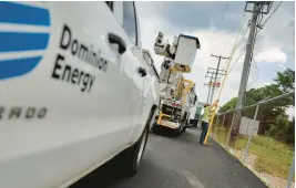  ?? STAFF FILE ?? Dominion Energy crews work to repair an electrical line in York County in 2020 after multiple trees were toppled by Tropical Storm Isaias. Power would be restored to more than 700 customers once the work was completed.