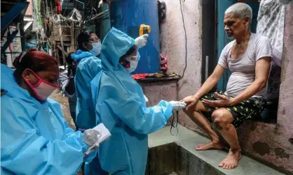  ??  ?? Health workers check the body temperatur­e of a resident inside the Dharavi slum in Mumbai. Photograph: Indranil Mukherjee/AFP/Getty Images
