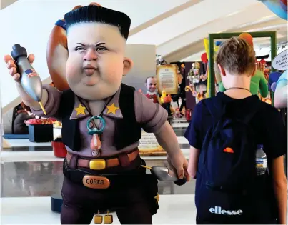  ?? Photo: Jose Jordan/Getty ?? A boy looks at a Ninot, a doll depicting a celebrity that will be set alight during the Fallas festival, representi­ng North Korean leader Kim Jong-Un in Valencia yesterday.