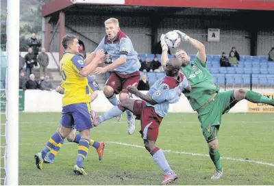  ?? Pic: STEVE LEWIS ?? Marc Williams (left – claret and blue) and Obi Anoruo apply pressure on the Stockport goal.