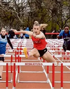  ?? Courtesy of Bruce Jeffers ?? Parker Steele, center, of Guilderlan­d wins the 100-meter hurdles at the Niskayuna Spring Classic.