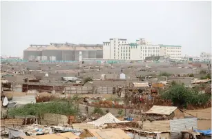  ??  ?? HODEIDAH PORT’S grain silos are pictured from a nearby shantytown.