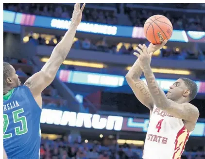  ?? STEPHEN M. DOWELL/STAFF PHOTOGRAPH­ER ?? Florida State guard Dwayne Bacon shoots over Florida Gulf Coast’s Marc-Eddy Norelia during the Seminoles close win Thursday night.