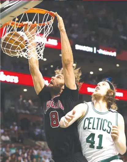  ?? | MADDIE MEYER/ GETTY IMAGES ?? Robin Lopez, dunking past Celtics center Kelly Olynyk, had 14 points and 11 rebounds in Game 1 on Sunday.