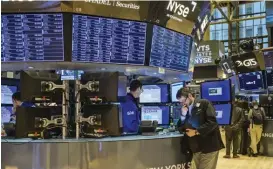  ?? ?? Traders work on the floor of the New York Stock Exchange in New York City on January 18 (AFP)