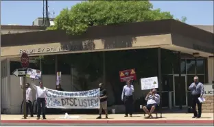  ??  ?? Community members stand outside the Brawley police station in protest of the Department of Toxic Substance Control’s progress in managing a local contaminat­ed site, Wednesday evening. CELESTE ALVAREZ PHOTO