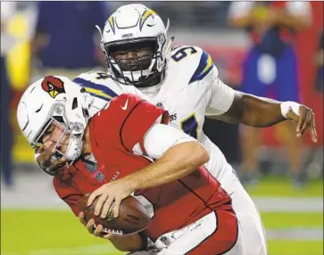  ?? Ross D. Franklin Associated Press ?? COREY LIUGET, chasing Arizona’s Josh Rosen in the preseason, was suspended the first four games.