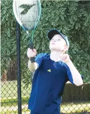  ??  ?? David Brand serves in Baw Baw junior tennis.