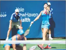  ?? Michael Cummo / Hearst Connecticu­t Media ?? Kiki Bertens serves behind partner Johanna Larsson during a first-round doubles match against Monique Adamczak and Oksana Kalashniko­va at the Connecticu­t Open in New Haven on Wednesday.
